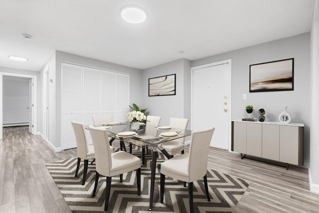 74 Springvale Ave Unit 7, Chelsea, MA 02150 - dining space with light wood finished floors, baseboard heating, and baseboards