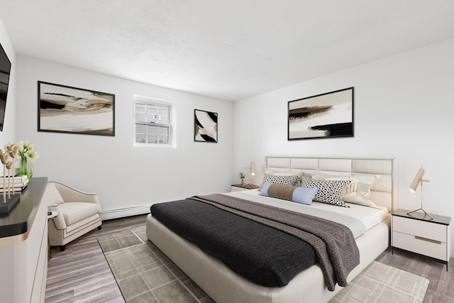 74 Springvale Ave Unit 7, Chelsea, MA 02150 - bedroom with wood finished floors, a baseboard heating unit, and baseboards