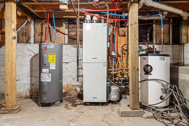 utility room featuring heating unit, gas water heater, and electric water heater