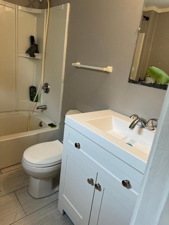 full bathroom with vanity, bathtub / shower combination, toilet, and wood finished floors
