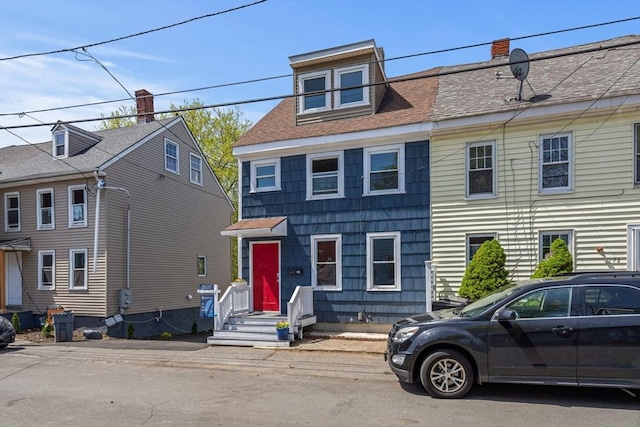 multi unit property featuring a shingled roof