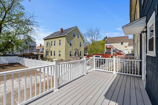 wooden deck with a fenced backyard
