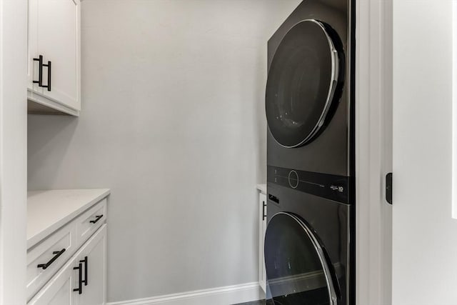 29 Sheppard Rd, Bourne, MA 02562 - laundry area with estacked washer and dryer, cabinet space, and baseboards