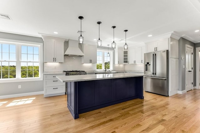 29 Sheppard Rd, Bourne, MA 02562 - kitchen with high end refrigerator, custom exhaust hood, baseboards, light countertops, and tasteful backsplash