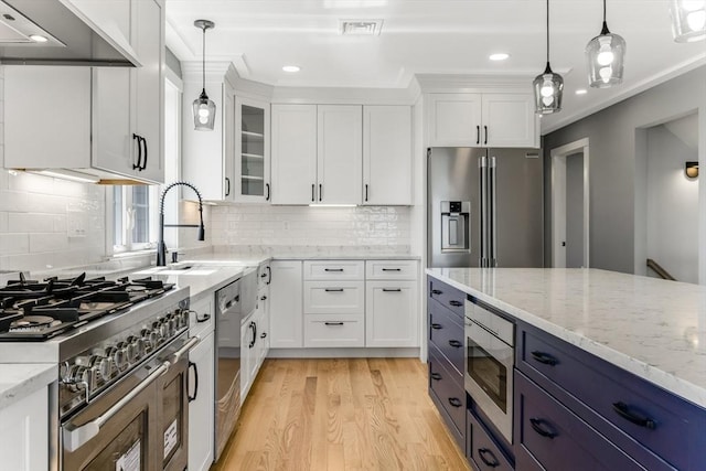 29 Sheppard Rd, Bourne, MA 02562 - kitchen with appliances with stainless steel finishes, white cabinets, light wood finished floors, glass insert cabinets, and recessed lighting