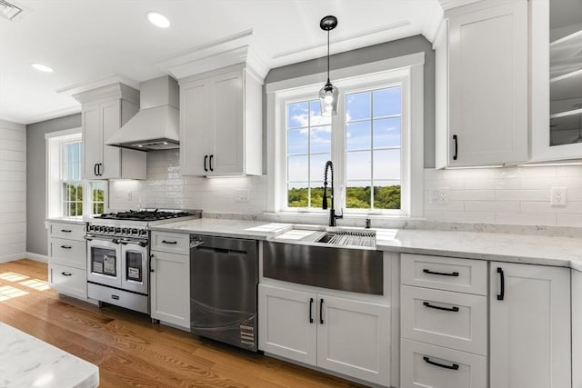 29 Sheppard Rd, Bourne, MA 02562 - kitchen with stainless steel appliances, premium range hood, a sink, light wood-style floors, and healthy amount of natural light