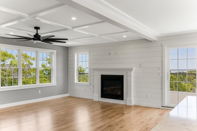 29 Sheppard Rd, Bourne, MA 02562 - unfurnished living room featuring light wood-style flooring, healthy amount of natural light, coffered ceiling, a glass covered fireplace, and beamed ceiling