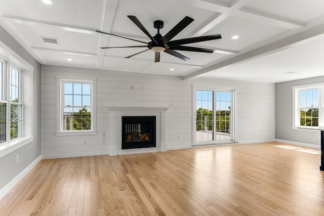 29 Sheppard Rd, Bourne, MA 02562 - unfurnished living room featuring light wood finished floors, beam ceiling, baseboards, a glass covered fireplace, and ceiling fan