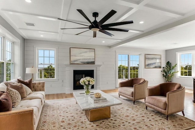 29 Sheppard Rd, Bourne, MA 02562 - living area with beamed ceiling, coffered ceiling, light wood-style floors, a fireplace, and ceiling fan