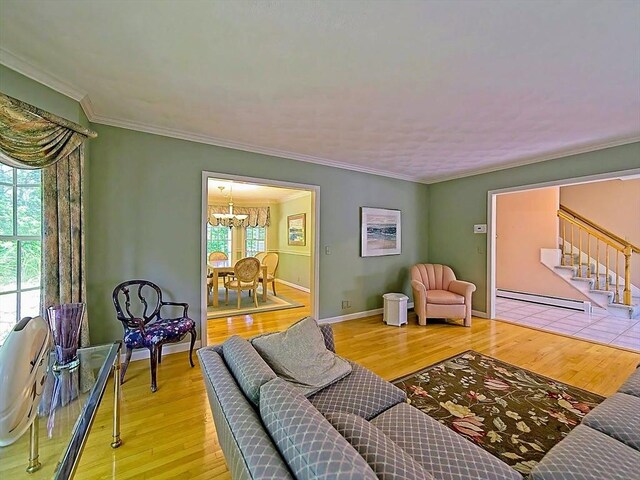 46 Clear Pond Rd, Falmouth, MA 02540 - living room with baseboard heating, a chandelier, stairway, crown molding, and wood finished floors