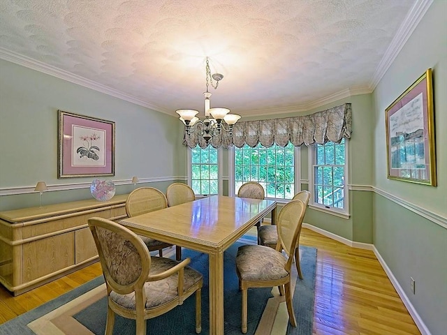 46 Clear Pond Rd, Falmouth, MA 02540 - dining space with a chandelier, plenty of natural light, light wood-style flooring, crown molding, and a textured ceiling