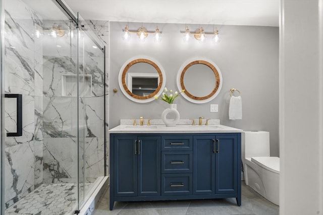 bathroom with toilet, a marble finish shower, and double vanity