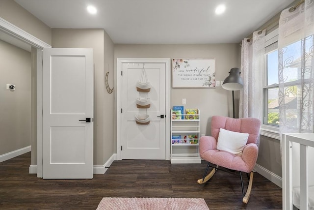 sitting room with baseboards, healthy amount of natural light, wood finished floors, and recessed lighting