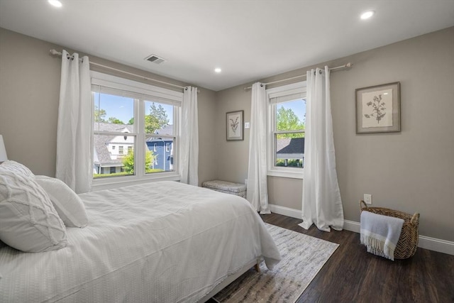 bedroom with baseboards, dark wood finished floors, and recessed lighting