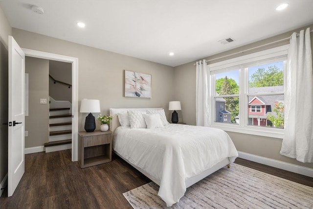 bedroom featuring baseboards, dark wood-style floors, and recessed lighting