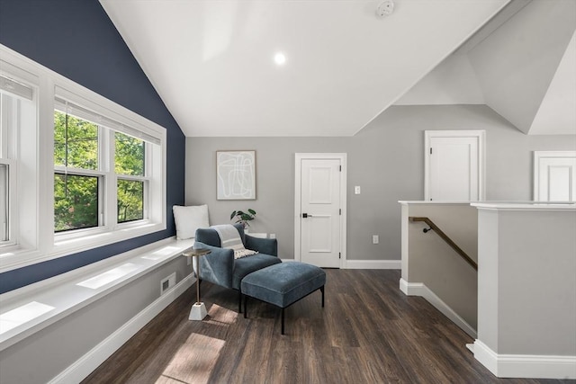 living area featuring vaulted ceiling, an upstairs landing, wood finished floors, and baseboards