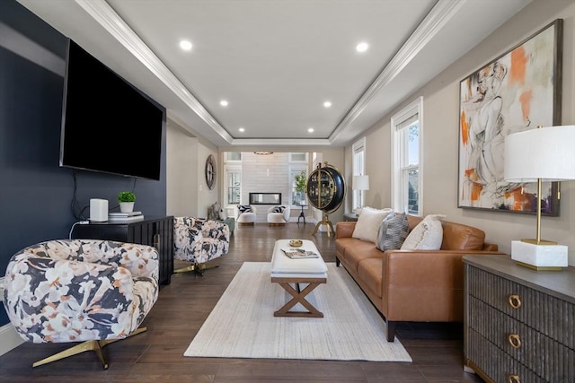 living room with dark wood finished floors, a raised ceiling, and recessed lighting