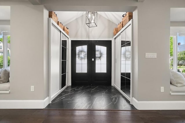 entrance foyer featuring baseboards, french doors, and marble finish floors