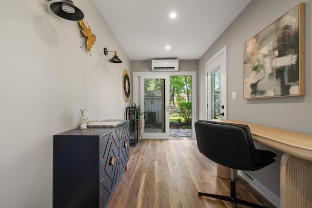 office area featuring a wall mounted AC, light wood-type flooring, and recessed lighting