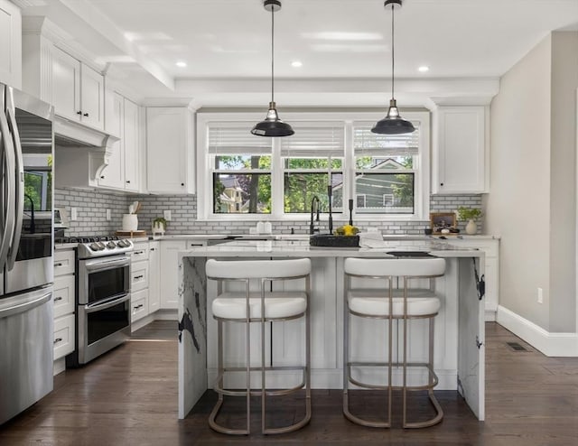 kitchen with appliances with stainless steel finishes, decorative backsplash, plenty of natural light, a center island, and recessed lighting