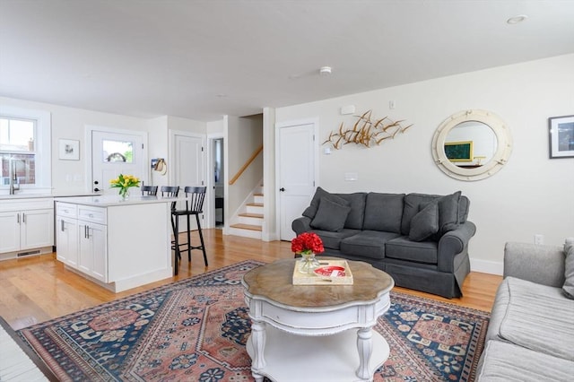 6 Macdonald Ter Unit E, Scituate, MA 02066 - living room with stairway, light wood-type flooring, and baseboards