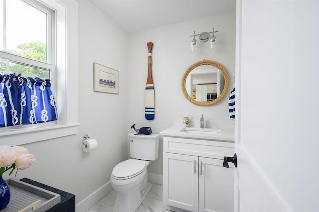 6 Macdonald Ter Unit E, Scituate, MA 02066 - bathroom with marble look tiles, vanity, baseboards, and toilet