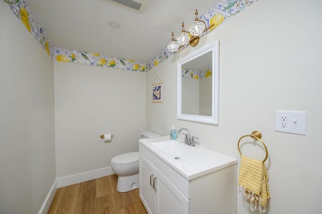 6 Macdonald Ter Unit E, Scituate, MA 02066 - bathroom with wood finished floors, toilet, vanity, and baseboards