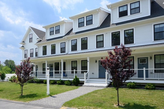6 Macdonald Ter Unit E, Scituate, MA 02066 - view of front of property with covered porch, a front lawn, and a shingled roof