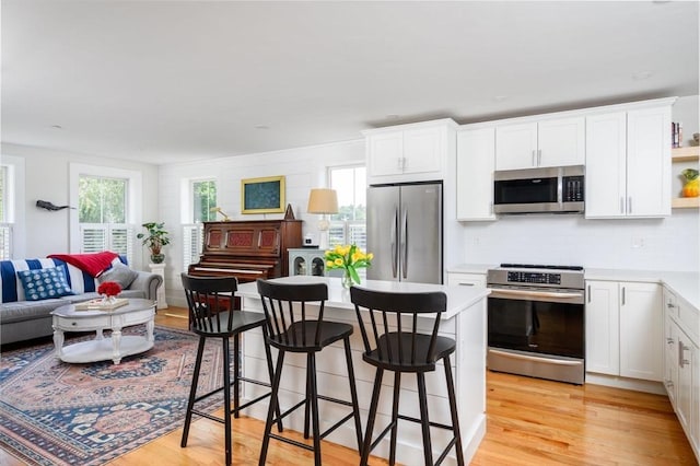 6 Macdonald Ter Unit E, Scituate, MA 02066 - kitchen with appliances with stainless steel finishes, light wood-type flooring, and white cabinets