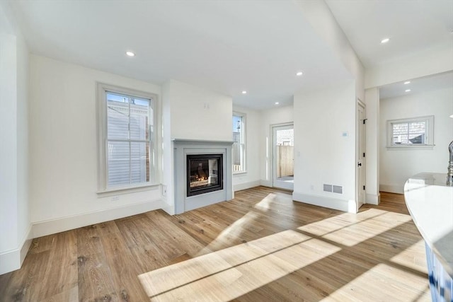 unfurnished living room featuring light hardwood / wood-style flooring