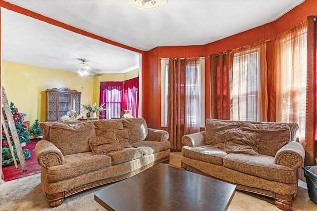 carpeted living room featuring ceiling fan