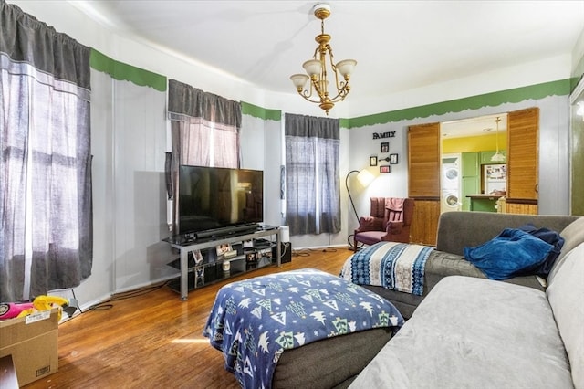 living room featuring hardwood / wood-style floors and an inviting chandelier