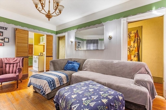 living room with hardwood / wood-style floors and a notable chandelier