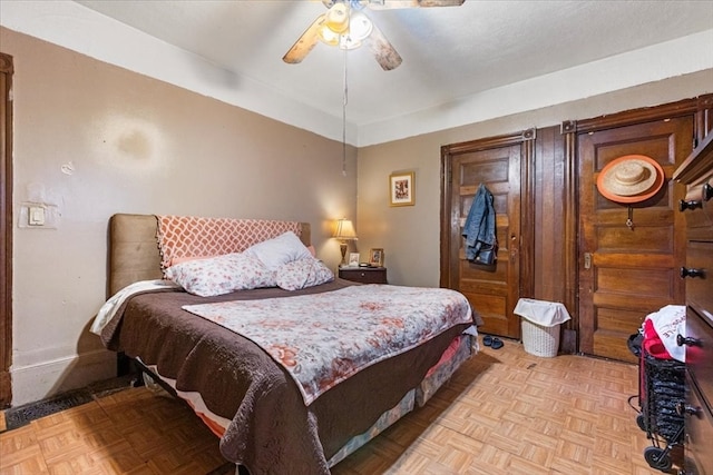 bedroom featuring ceiling fan and light parquet flooring