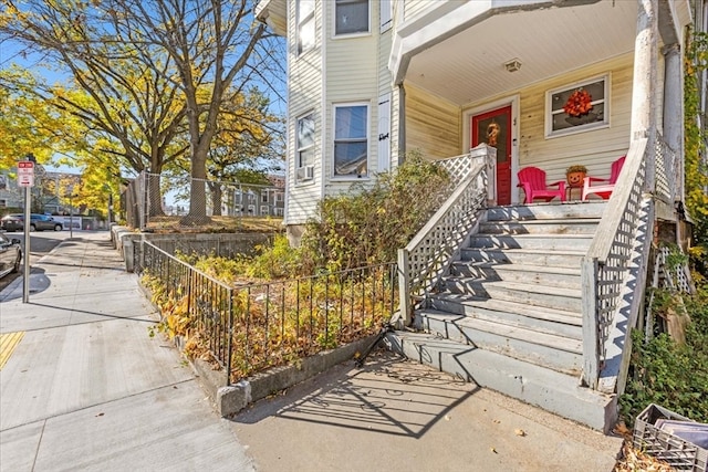 entrance to property featuring cooling unit and covered porch