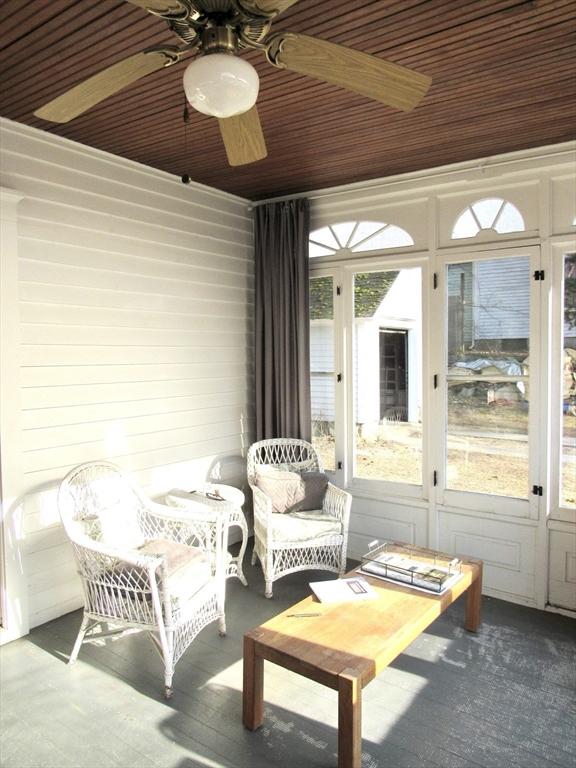 sunroom / solarium featuring wooden ceiling and ceiling fan