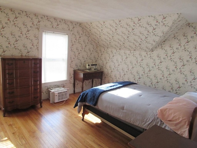 bedroom with light wood-style flooring and wallpapered walls