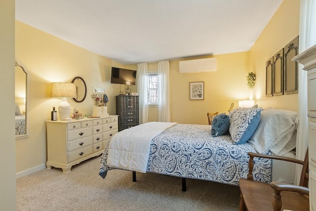 bedroom featuring baseboards, light carpet, and a wall mounted air conditioner