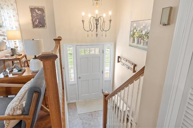 foyer with an inviting chandelier, a towering ceiling, and stairway
