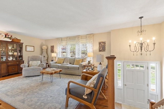 living area featuring a chandelier and light wood-style flooring