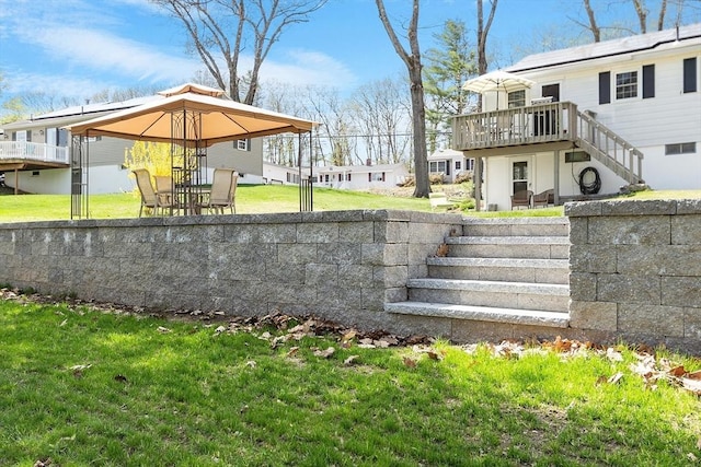 view of yard with stairs, a wooden deck, and a gazebo