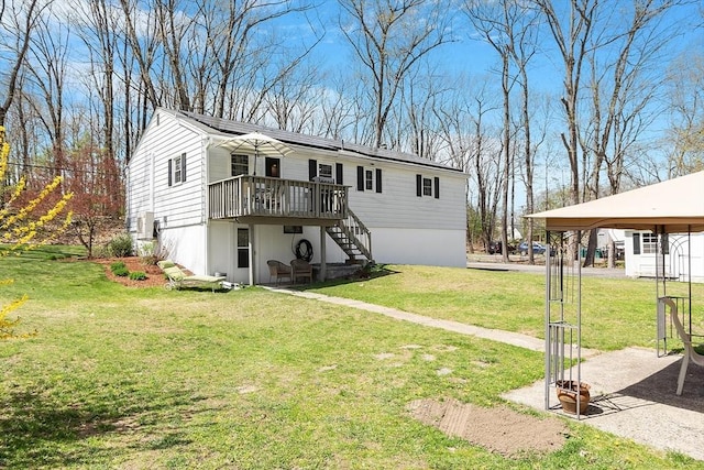 view of front of house with stairs, a front yard, and a deck