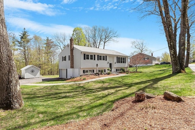 exterior space with a storage shed, a garage, a chimney, a yard, and driveway