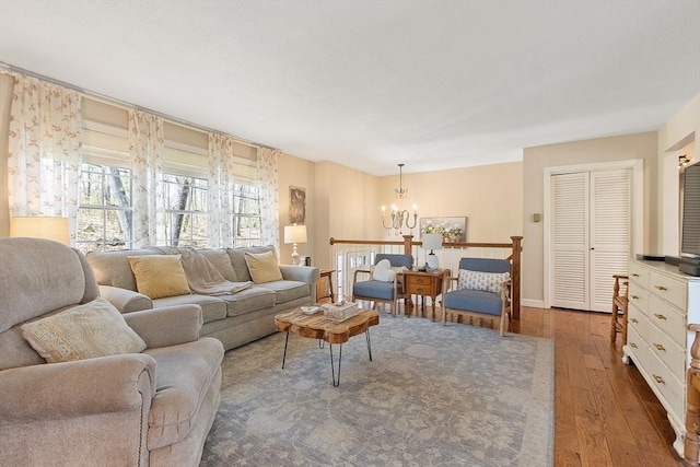 living area featuring an inviting chandelier and hardwood / wood-style floors
