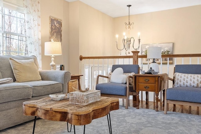 living area with an inviting chandelier and carpet floors
