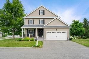 5 Comanche Cir Unit 5, Haverhill, MA 01835 - traditional home with covered porch, a front yard, driveway, and a garage