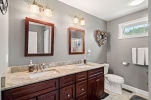 5 Comanche Cir Unit 5, Haverhill, MA 01835 - bathroom with toilet, double vanity, and baseboards