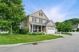 5 Comanche Cir Unit 5, Haverhill, MA 01835 - view of front of house featuring a porch, a front yard, a garage, and driveway