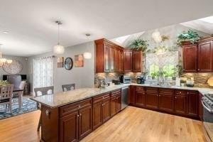 5 Comanche Cir Unit 5, Haverhill, MA 01835 - kitchen with plenty of natural light, light wood finished floors, a peninsula, and lofted ceiling