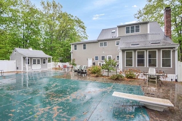 17 Stable Way, Medway, MA 02053 - view of pool featuring a diving board, a patio, an outbuilding, and a storage structure